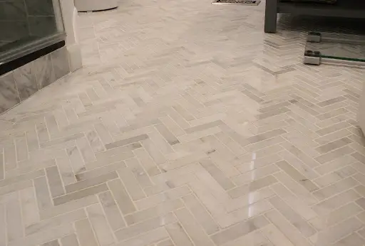 Completed heated floor with herringbone tile pattern – Spruce Grove home